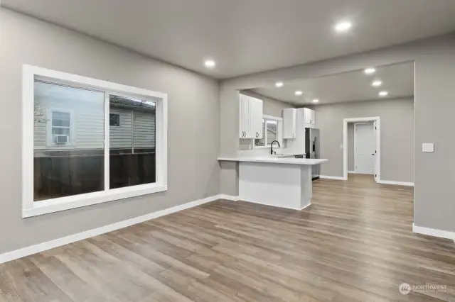 Living room, kitchen, opening to laundry room and back door