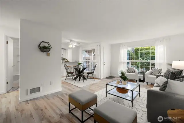 View from the south corner of the living room into dining area and front windows.