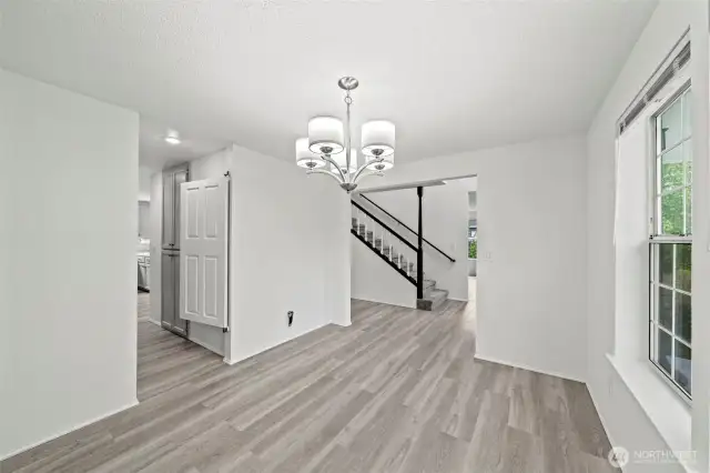 New LVP flooring throughout! This is the formal dining room, with a butlers pantry/hallway directly into the kitchen.