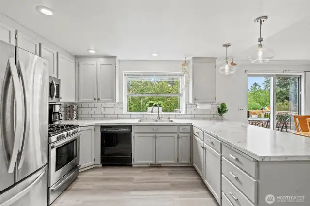 Beautiful kitchen opens to the main living area and offers TONS of pantry space. Check out the not 1, not 2, but 3 pantry spaces!