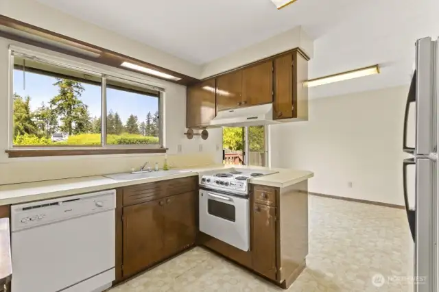 Calling all visionaries! This kitchen is ready for a glow-up. Functional layout, charming built-ins, and a sunny window over the sink make it a prime candidate for your dream renovation.
