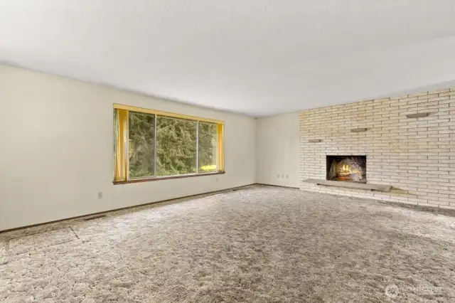 Spacious, light-filled living room with a huge picture window.