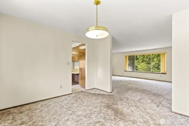Separate dining space with backyard views—easy flow into the kitchen and just the right size for a round table and your next pasta night.