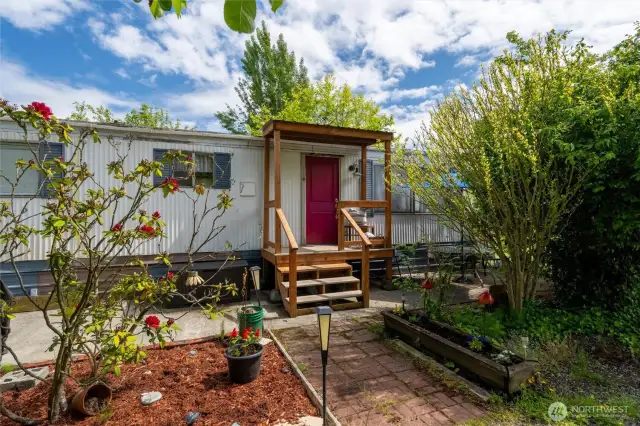 Welcoming Front Entry- Charming beach retreat with a bright pop of color! This inviting front porch welcomes you home to your own slice of Birch Bay. Surrounded by greenery and garden space, this 2-bedroom beach cottage is just blocks from the waterfront.