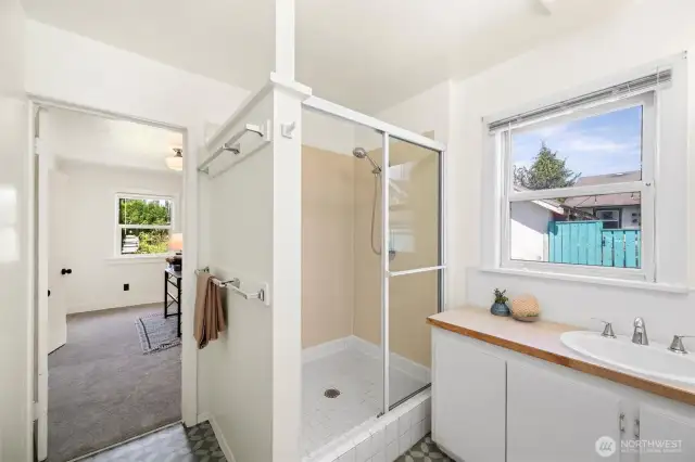 The roomy 3/4 bath is accessed from the back bedroom (pictured here) or through the kitchen.