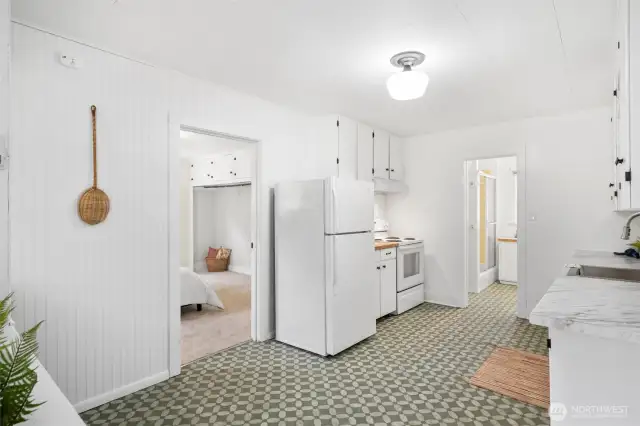 The door to the left leads into the bedroom, with the door on the right leading into the kitchen.