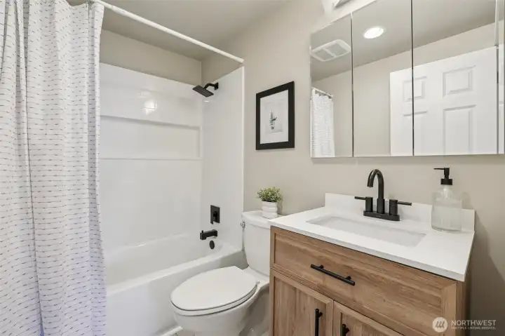 The main full bathroom has been remodeled, featuring brand new flooring, a stunningly updated shower, and a fresh, modern vanity, all contributing to a revitalized and comfortable space.