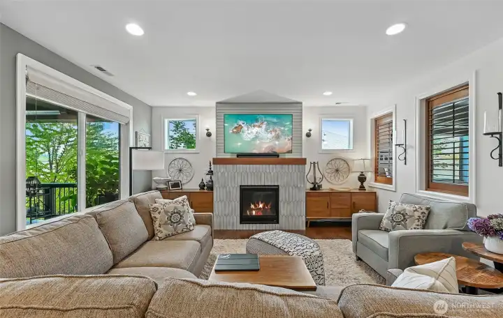 The gas fireplace has a surround of tiles that match the backsplash in the kitchen.