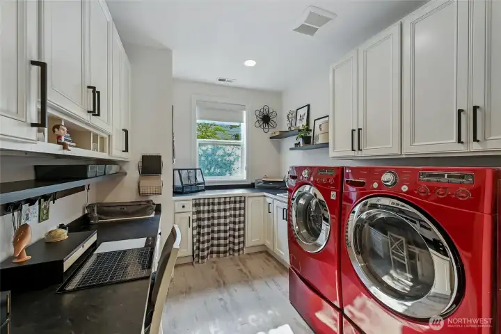 Off the kitchen is a fabulous laundry room with a desk space, project space and a laundry sink. So much storage in this room!