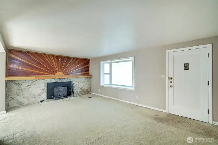 Living room with wood burning fireplace.