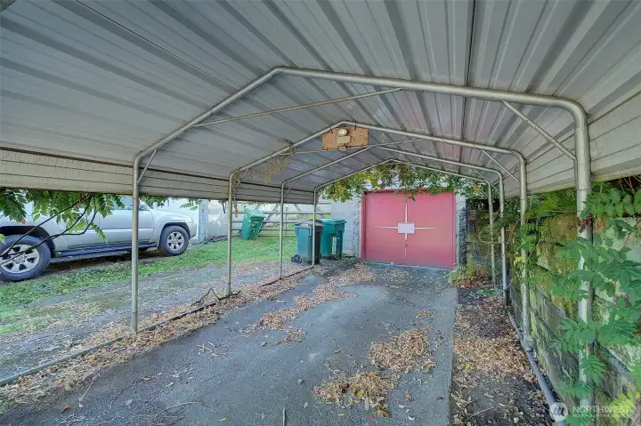 Carport structure over driveway and entrance to home.