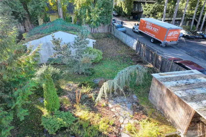 Gate bordering 23rd Ave NE opens to access garage structure.