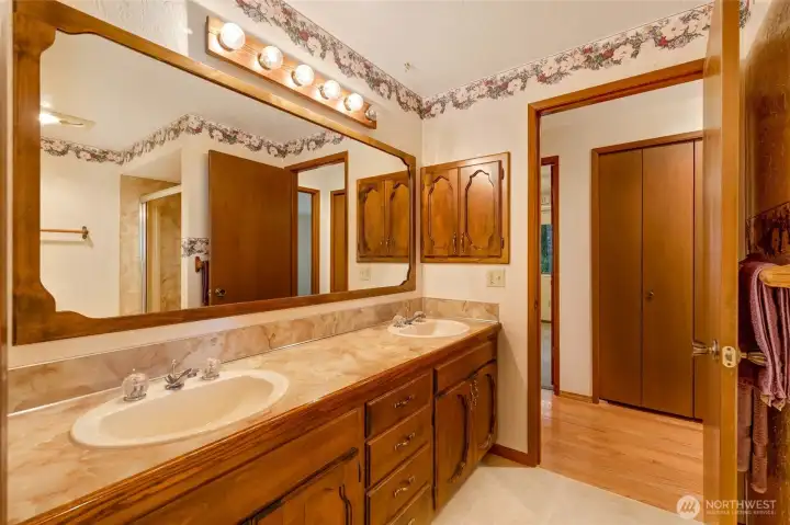 Full bath also boasts dual sinks and tons of counter and cabinet space.