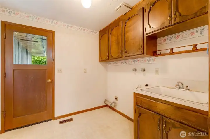 The convenient utility room with a sink makes laundry, cleaning, and household projects easier, giving you practical space without sacrificing style.