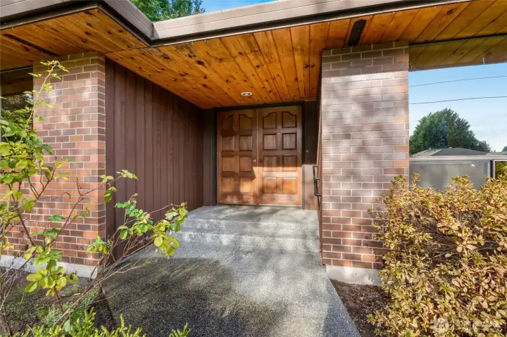 The charming covered front entryway welcomes guests with style and shelter, offering a cozy spot to pause before entering the home and adding curb appeal to this inviting rambler.