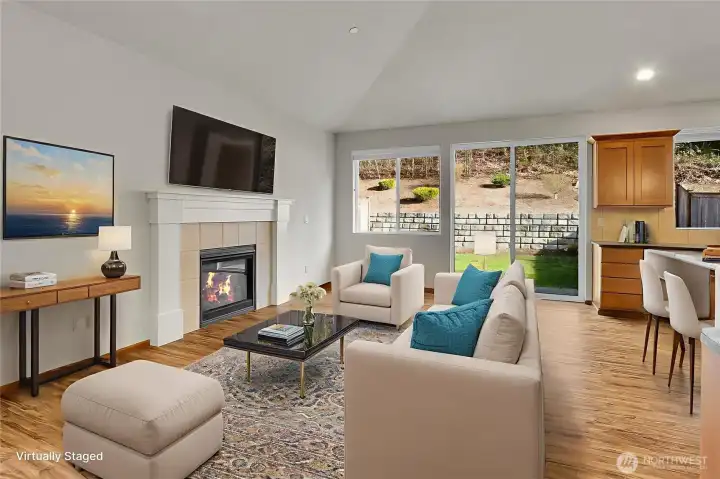 Cozy fireplace and lots of room to spread out in the Great Room. Virtually staged.