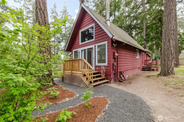 This storybook A-frame sits quietly among towering evergreens, offering standout curb appeal and the peaceful forest setting buyers crave.