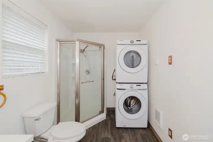 The laundry room’s walls and ceiling were taken to the studs and rebuilt, creating a brighter, more modern space without altering the existing cabinetry or flooring.