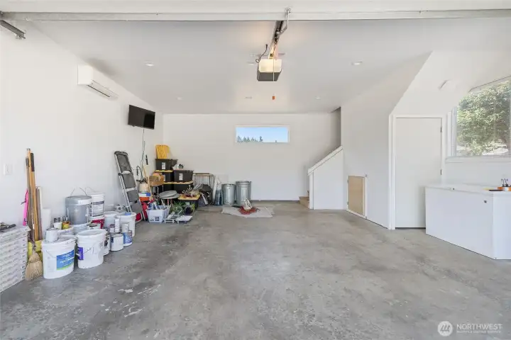 The garage and shop are fully insulated and equipped with a ductless heat pump for year-round usability. The space is piped for an air compressor, which stays with the property, and includes a 50-amp outlet for electric vehicle charging. Built-in cabinetry and a mini fridge are included, along with a dedicated gun safe cabinet (safe not included). A 220-volt welding plug and a 200-amp service panel support a wide range of uses....