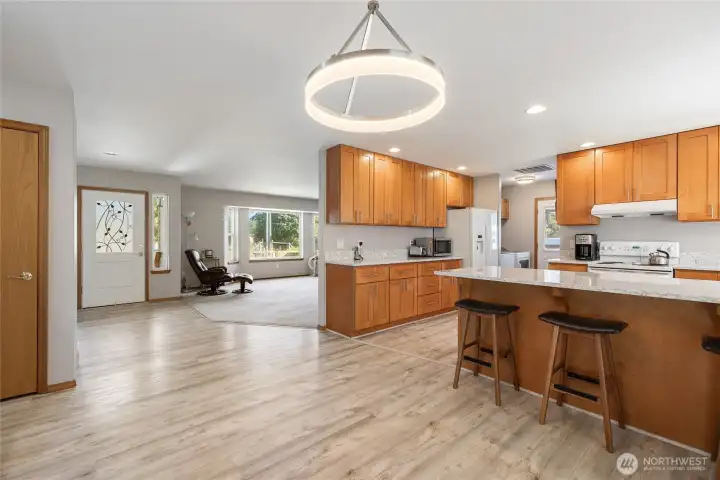 The kitchen was remodeled in 2023 with quartz countertops, upgraded hardwood cabinetry, and a built-in 48-bottle wine fridge. Durable LVP flooring runs throughout the home, paired with LED lighting for a bright, modern feel. The hot water tank was replaced in 2023, and the home features an electronic air filter with a REME HALO ionizer for improved air quality. Generator-ready circuitry and a 200-amp electrical panel add peace of mind....