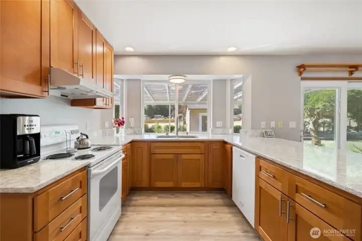 The kitchen was remodeled in 2023 with quartz countertops, upgraded hardwood cabinetry, and a built-in 48-bottle wine fridge. Durable LVP flooring runs throughout the home, paired with LED lighting for a bright, modern feel. The hot water tank was replaced in 2023, and the home features an electronic air filter with a REME HALO ionizer for improved air quality. Generator-ready circuitry and a 200-amp electrical panel add peace of mind.... The kitchen was remodeled in 2023 with quartz countertops, upgraded hardwood cabinetry, and a built-in 48-bottle wine fridge. Durable LVP flooring runs throughout the home, paired with LED lighting for a bright, modern feel. The hot water tank was replaced in 2023, and the home features an electronic air filter with a REME HALO ionizer for improved air quality. Generator-ready circuitry and a 200-amp electrical panel add peace of mind....