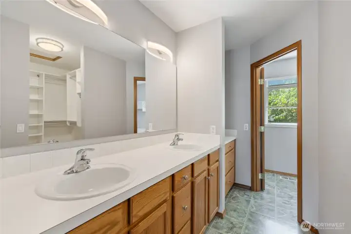 The primary suite is thoughtfully designed with custom California Closets and an ensuite bath. The bathroom features a six-foot soaking tub and a cable TV hookup, and all rooms in the home are wired for cable, including the primary bath.