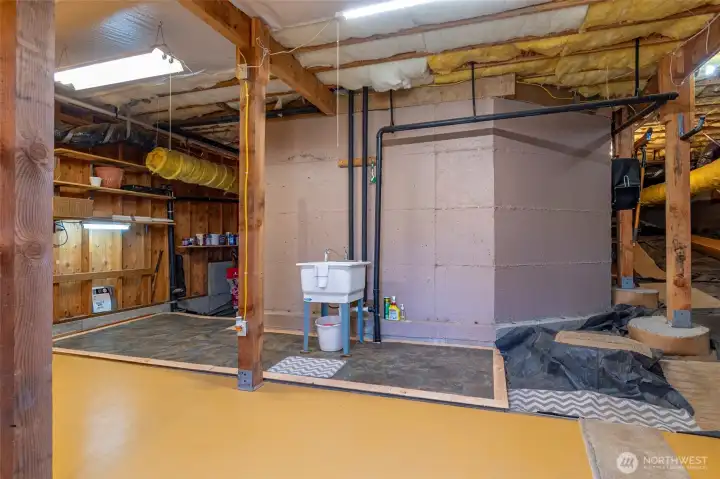 Workspace has easy clean flooring & deep sink