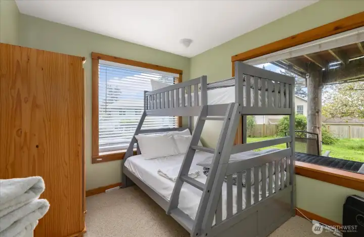 This is currently being used as an extra bedroom. It's a very flexible space. Maybe a light filled office or home gym?