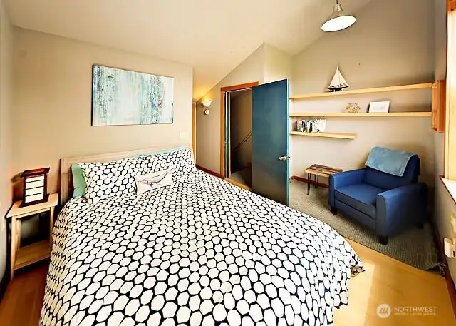 Upstairs bedroom with sitting area in the apartment.