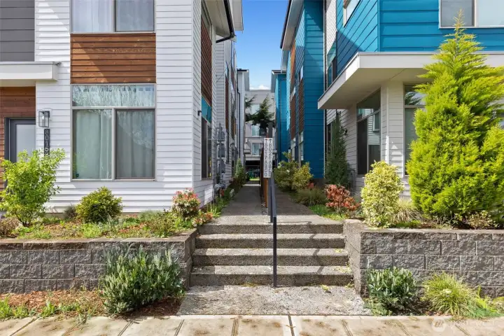 The home is off the street down a walkaway toward the back of the community.