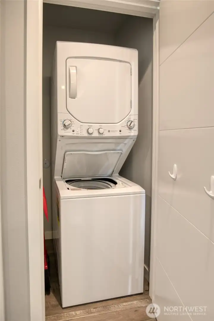 Stackable washer and dryer are in the hallway closet.