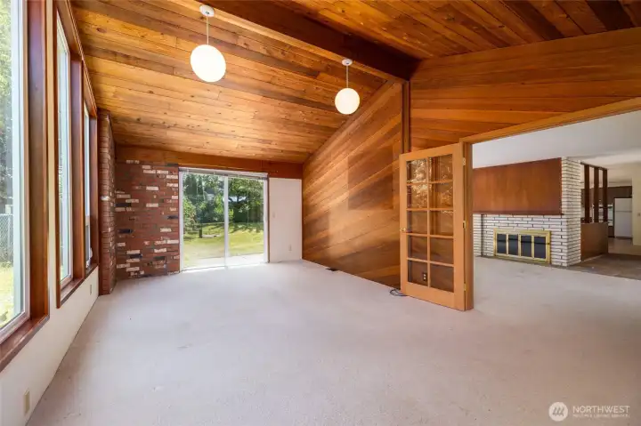 The bonus room, featuring more large windows for abundant natural light, French doors, vaulted ceilings.  So much potential in this room! From here you can see all the way through the main living spaces and into the kitchen.