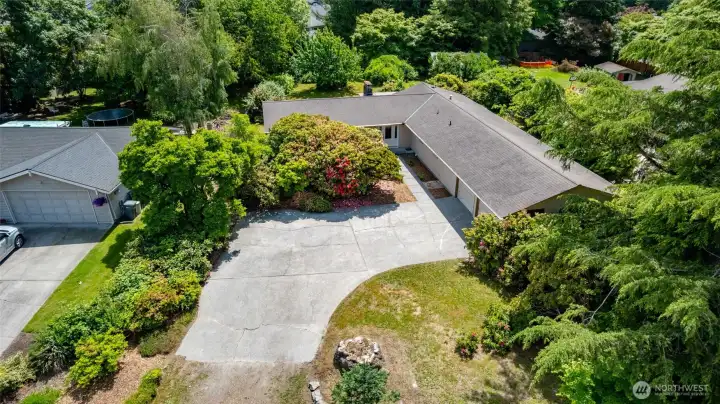 Aerial view of the house, garage, and front yard