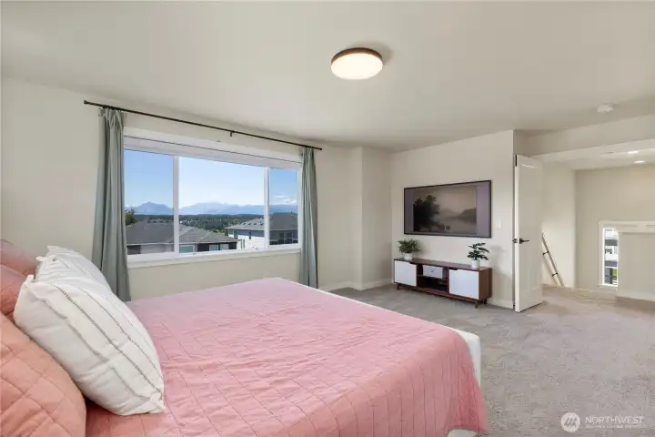 Bright secondary bedroom features plush low-pile carpeting, neutral paint tones, and regular traditional blinds over a wide window. Bright secondary bedroom features plush low-pile carpeting, neutral paint tones, and regular traditional blinds over a wide window.