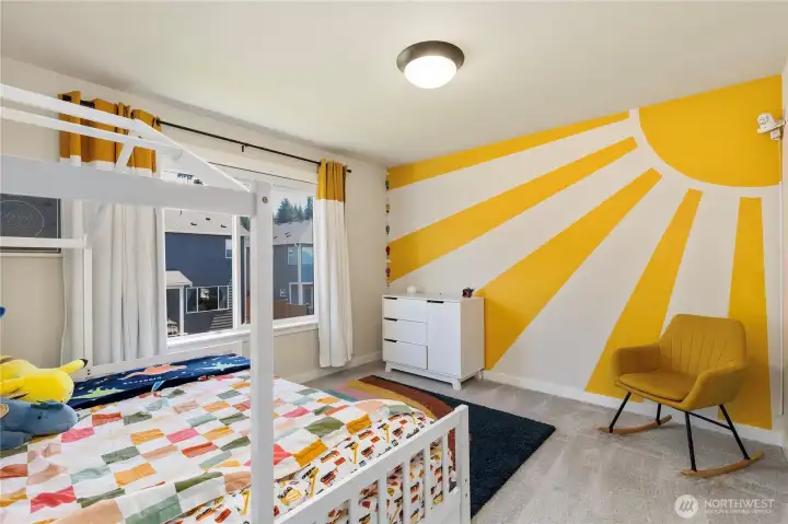 Charming bedroom features a vibrant accent wall painting, soft low-pile carpeting, regular traditional window blinds, and ample closet storage space. Charming bedroom features a vibrant accent wall painting, soft low-pile carpeting, regular traditional window blinds, and ample closet storage space.