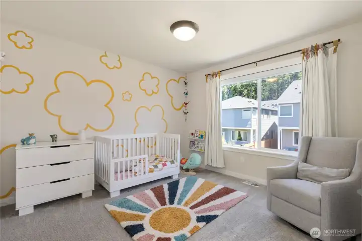 Sweet fourth bedroom features playful wall graphics, premium low-pile carpet, and a large window providing ample natural light. Sweet fourth bedroom features playful wall graphics, premium low-pile carpet, and a large window providing ample natural light.