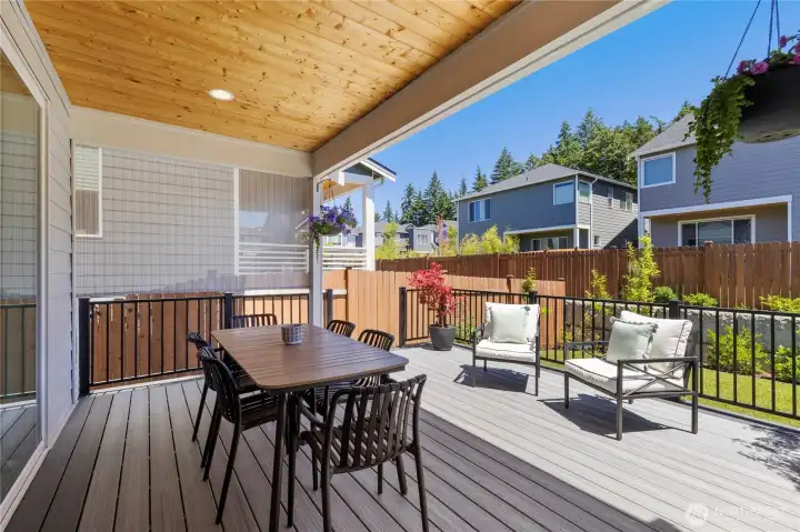 Lower-level outdoor living space features a covered concrete patio, perfect for shaded dining and easy transitions to the fully fenced lawn. Lower-level outdoor living space features a covered concrete patio, perfect for shaded dining and easy transitions to the fully fenced lawn.