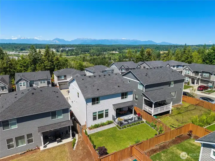 Birds-eye aerial view highlighting the prime Silverdale plot, private backyard border, proximity to Puget Sound amenities, and beautiful metal-accented rooflines Birds-eye aerial view highlighting the prime Silverdale plot, private backyard border, proximity to Puget Sound amenities, and beautiful metal-accented rooflines