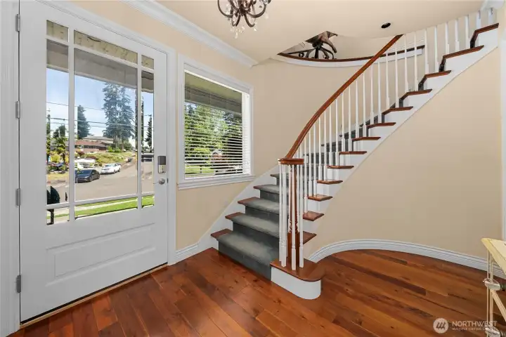 The front door opens up to this elegant spiral stair way