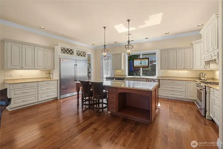 Elegance at its finest - huge 9"x5" granite island adorns the kitchen which boasts of high end appliances and custom cabinetry