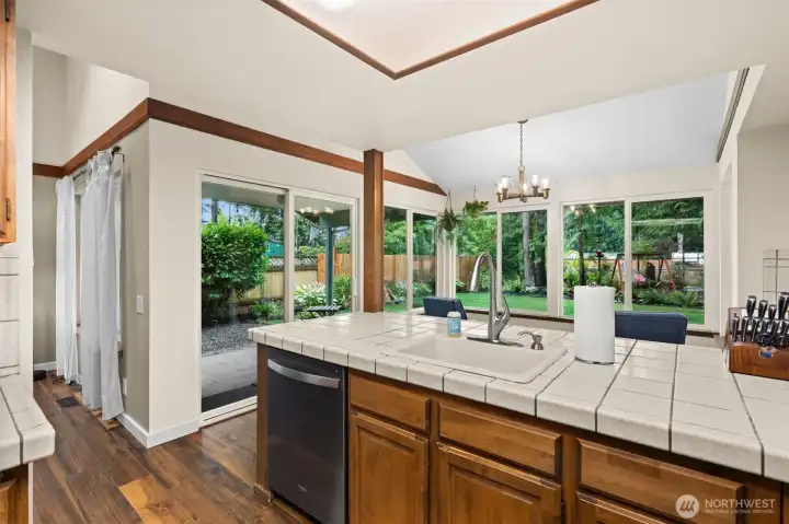 The kitchen extends into a spectacular, window-lined eating space that frames beautiful views of the backyard, flooding the entire heart of the home with brilliant natural light. The kitchen extends into a spectacular, window-lined eating space that frames beautiful views of the backyard, flooding the entire heart of the home with brilliant natural light.