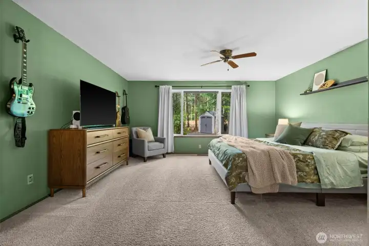 Incredible scale and style. This spacious primary bedroom easily accommodates a king-sized layout and a seating area, beautifully complemented by calming sage green walls and the luxury of an attached en-suite. Incredible scale and style. This spacious primary bedroom easily accommodates a king-sized layout and a seating area, beautifully complemented by calming sage green walls and the luxury of an attached en-suite.