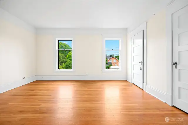 Huge primary bedroom with oak flooring