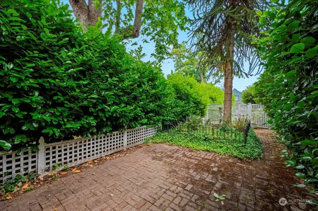 Large side yard with patio and English garden