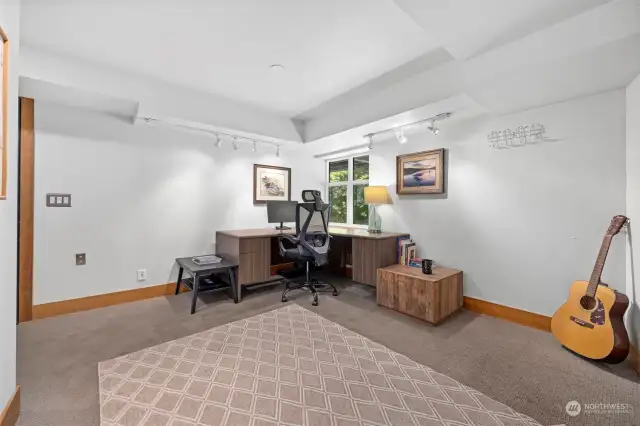 This lower level room currently serves as office and media space but also qualifies as a 4th bedroom if needed