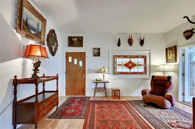 Looking from the dining room to the entrance of the home, with the sunporch to the right.