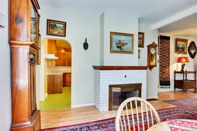 Downstairs wood fireplace and entrance to the kitchen