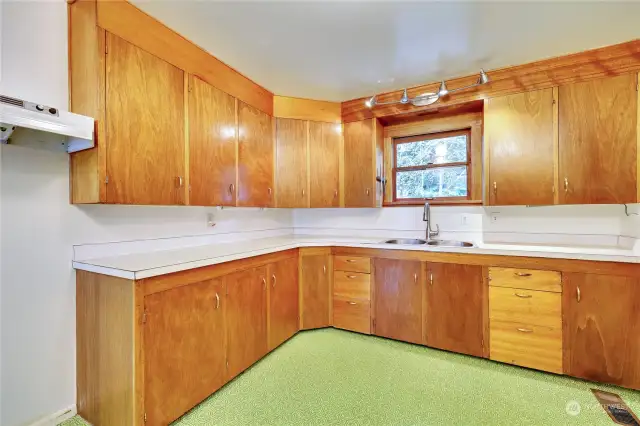 Kitchen boast these wonderful custom wood cabinets with plenty of space.