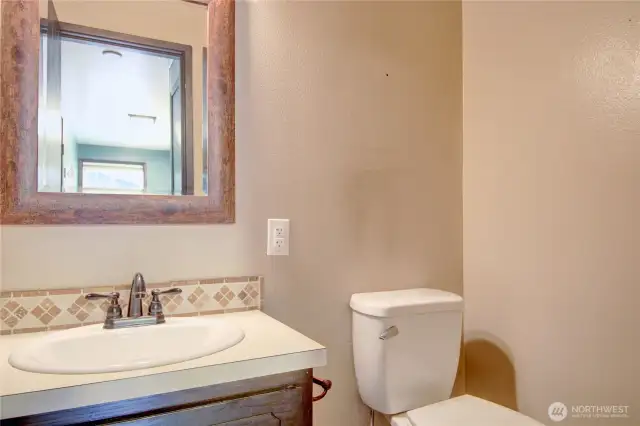 Half bath powder room located off of the laundry and kitchen.