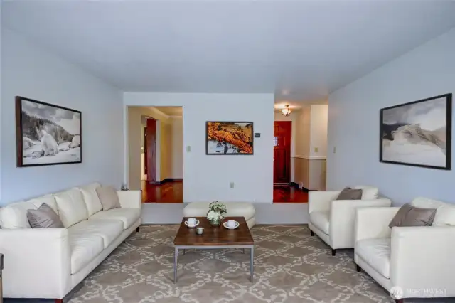 Virtually staged view of the living room looking toward the entry